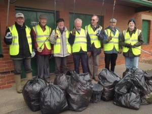 The seven Rotarians with litter pickers and bags.